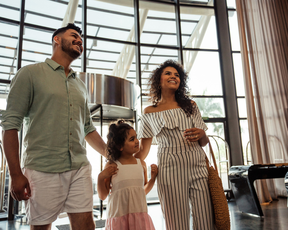 a man and a woman standing next to a window