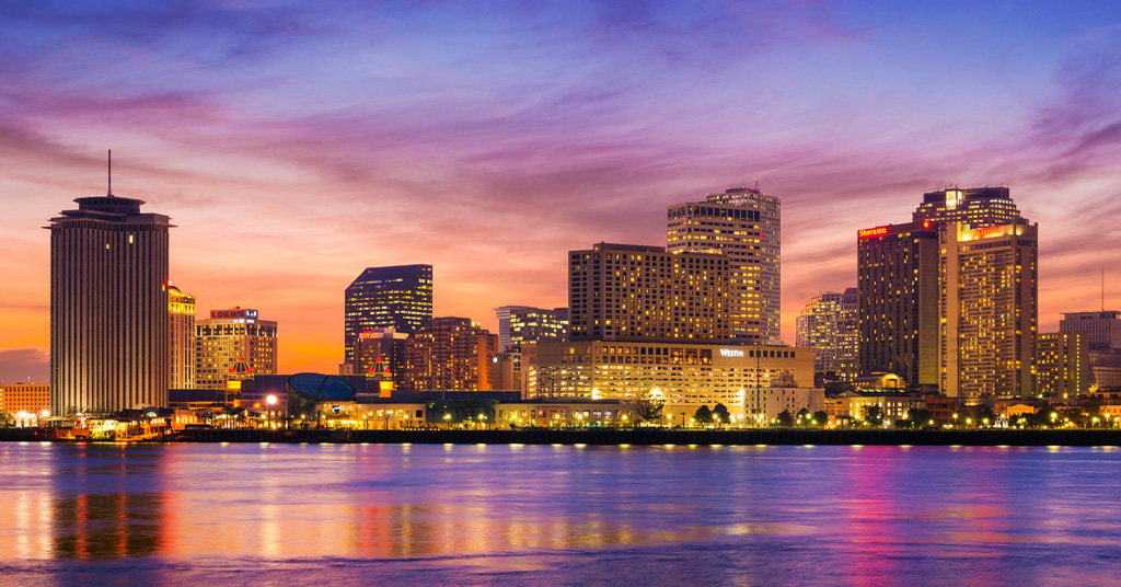 a bridge over a body of water with a city in the background