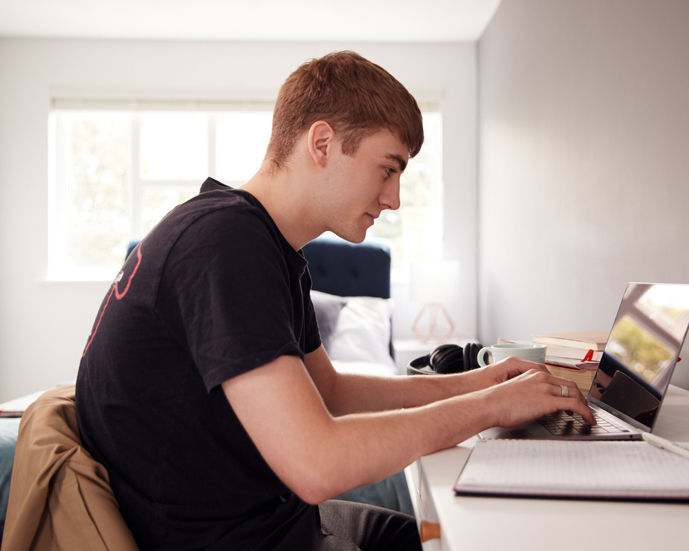 a man standing in front of a computer